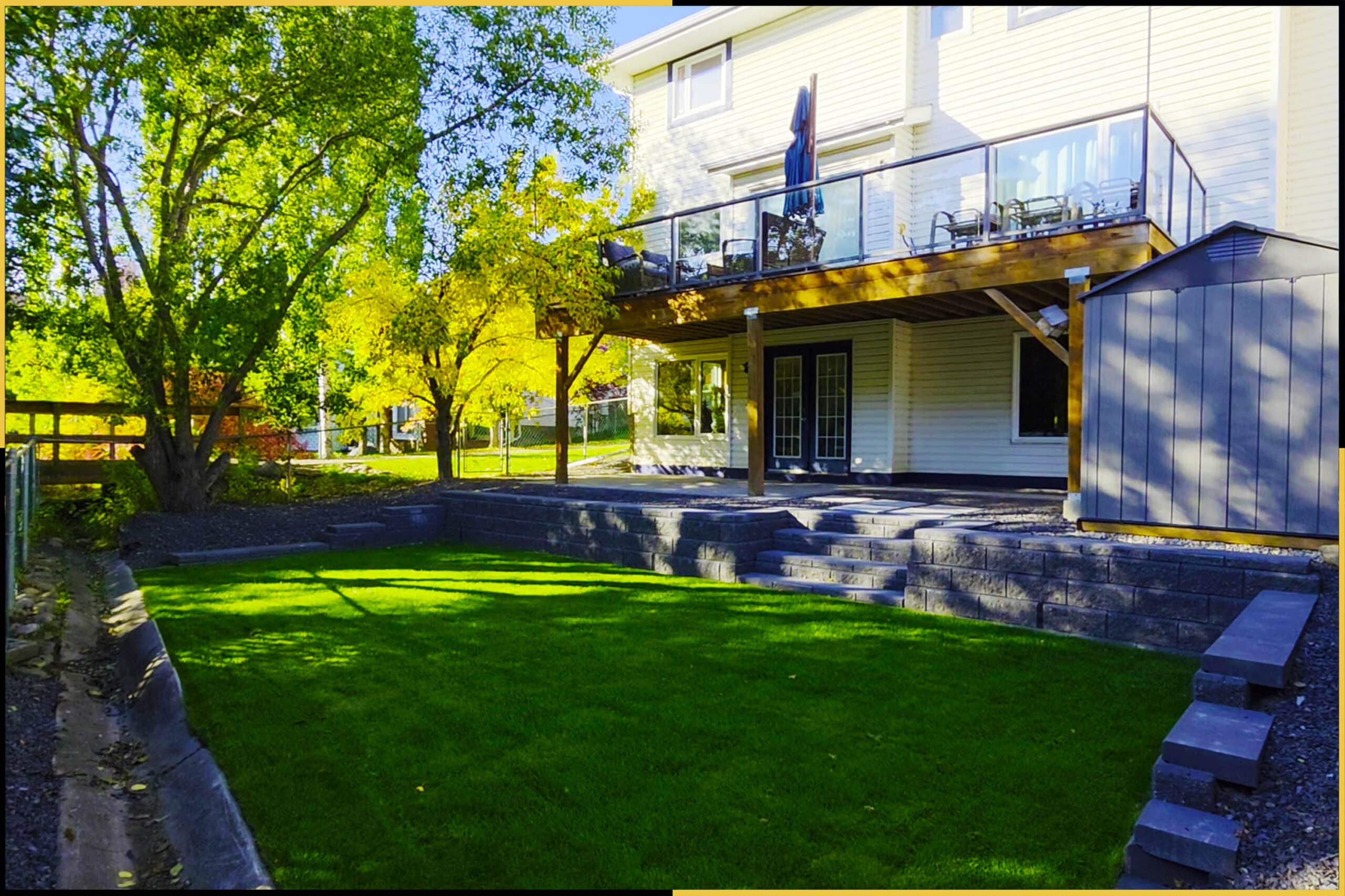 After: two-level backyard with retaining wall, steps and new sod